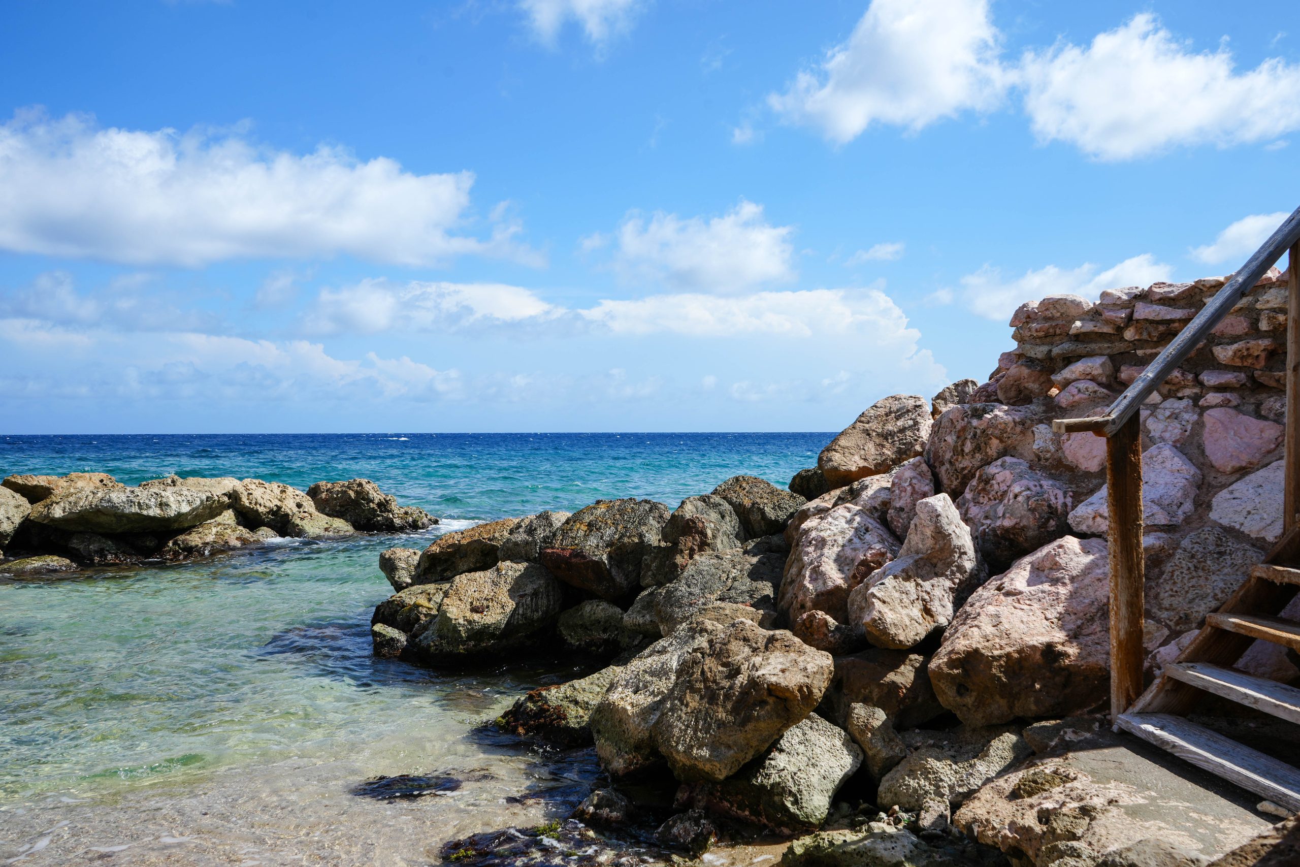 Rocky oceanfront with natural tidal pool access at Dushi Pietermaai Apartments, Curaçao