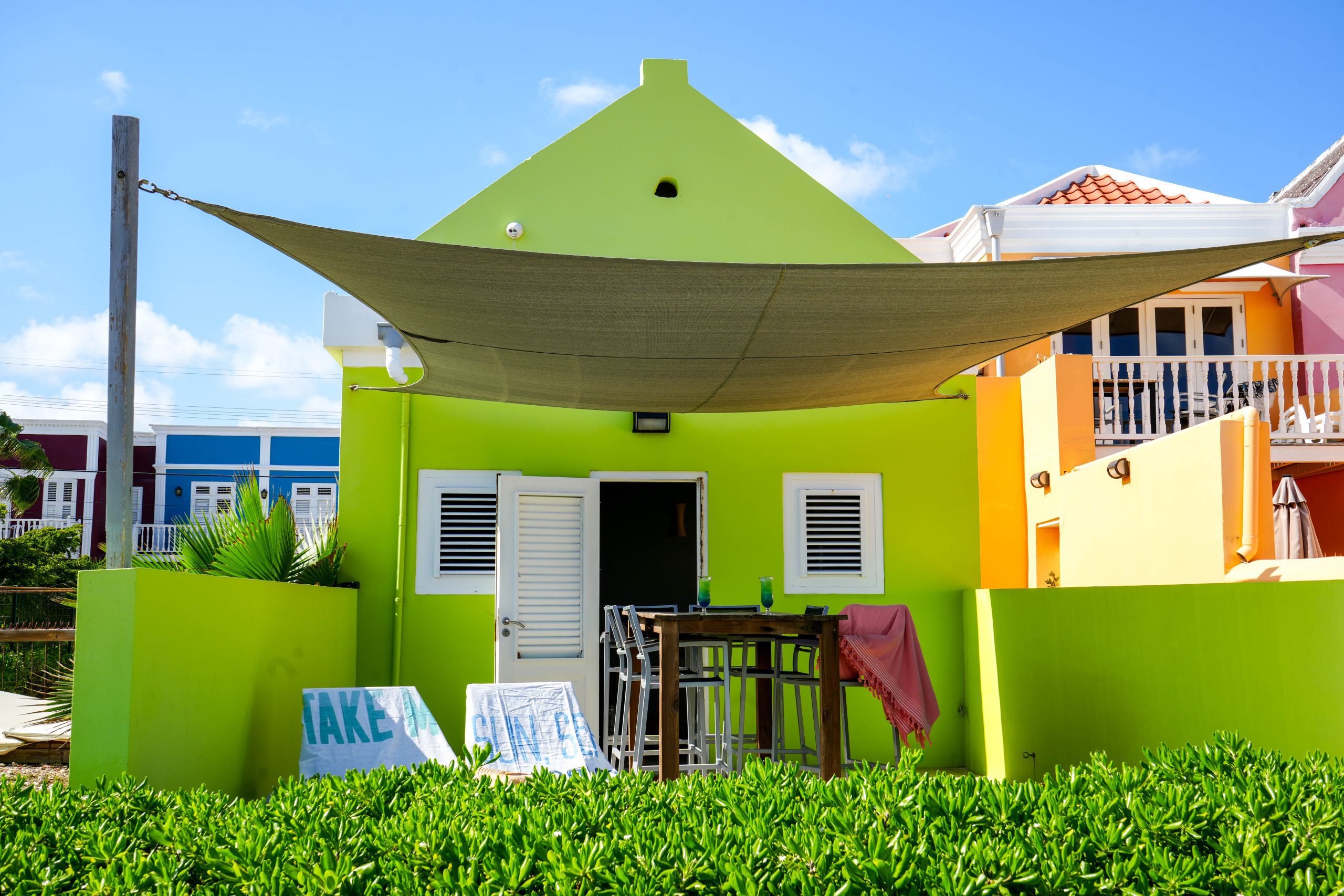 Colorful green exterior of Aqua family apartment in Pietermaai District, Curacao