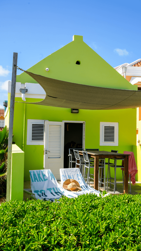 Bright green façade of Apartment Aqua in Pietermaai, Curaçao