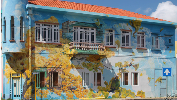 Colourful street art mural on a historic Curaçao building in Willemstad