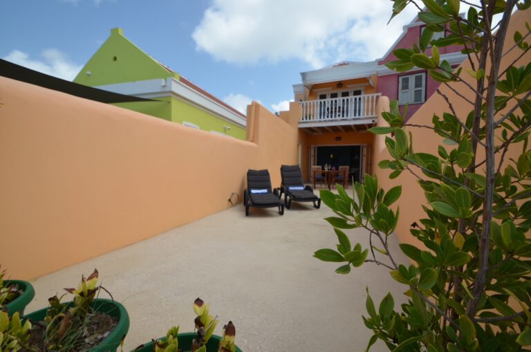 Spacious private patio surrounded by colourful Caribbean walls – Luna apartment, Pietermaai