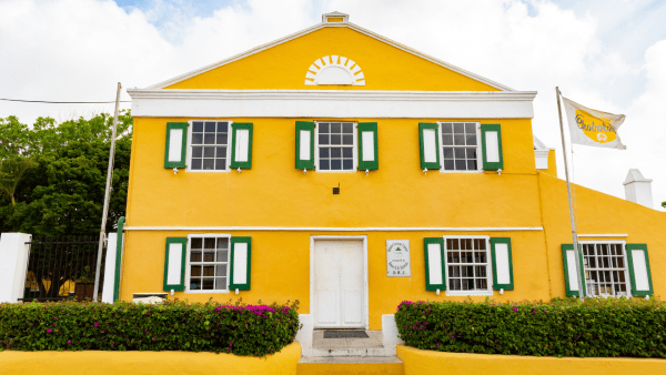 Bright yellow restored plantation house with white trim – Curaçao