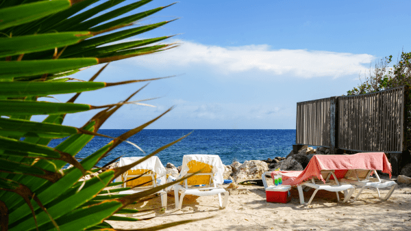 Beachfront chairs and ocean view at Dushi Pietermaai Apartments in Curaçao, highlighting tips before arrival