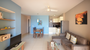 Open-plan oceanfront apartment Luna with tropical decor and light blue walls – Dushi Pietermaai Apartments