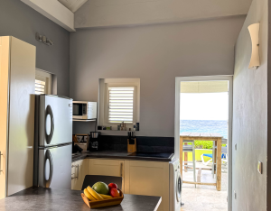 Modern open kitchen and seating area in Aqua apartment – Pietermaai, Curaçao