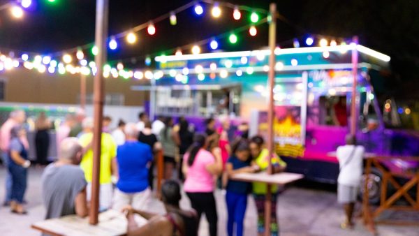 Colourful food truck night market with lights and locals – Curaçao