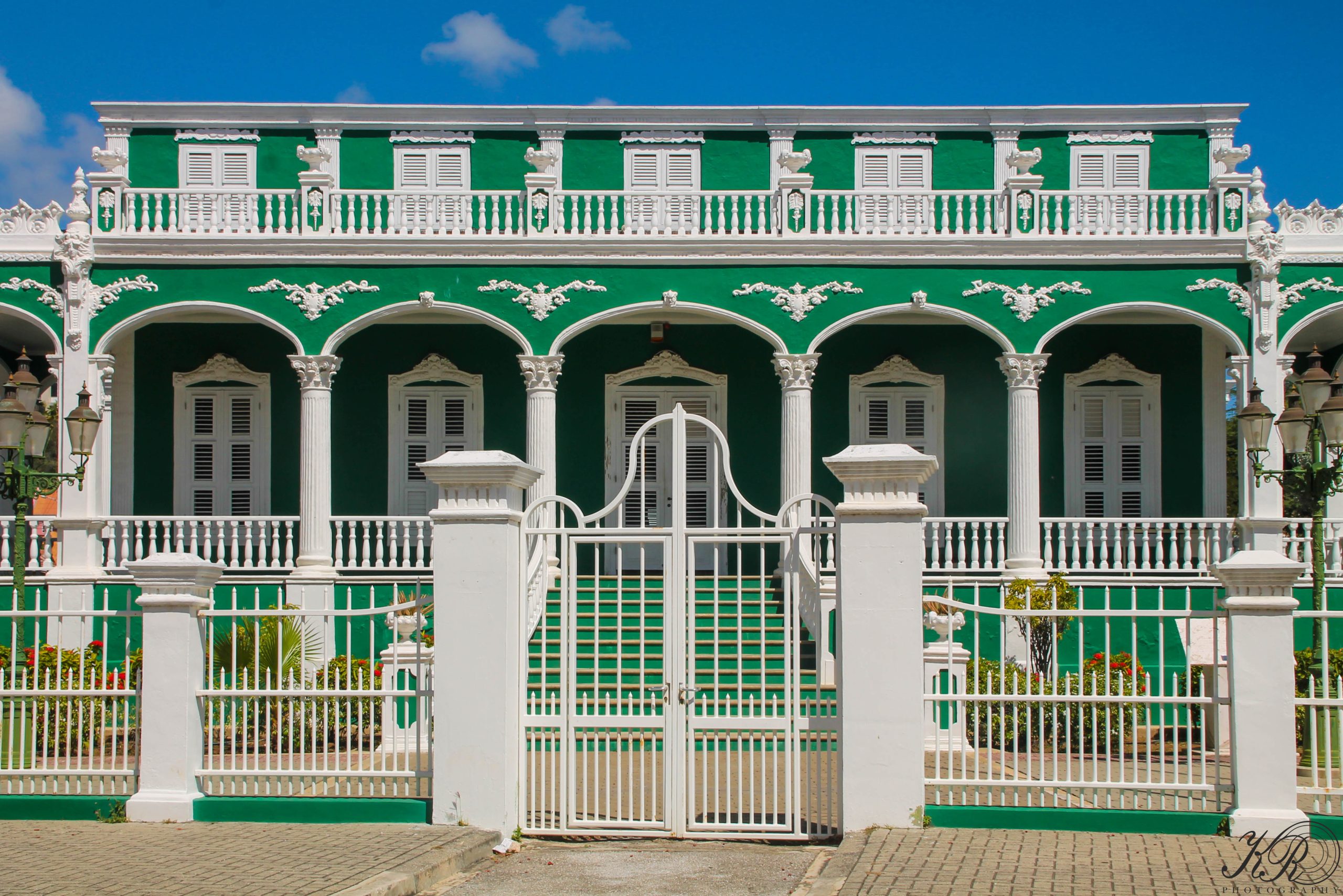 Historic green and white colonial building in Pietermaai, Willemstad – UNESCO World Heritage